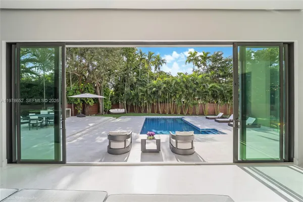 a view of a patio with table and chairs potted plants with sky view