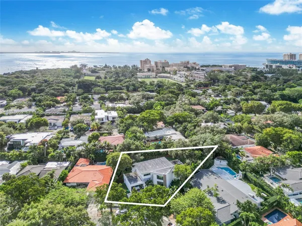 an aerial view of house with yard swimming pool and outdoor seating
