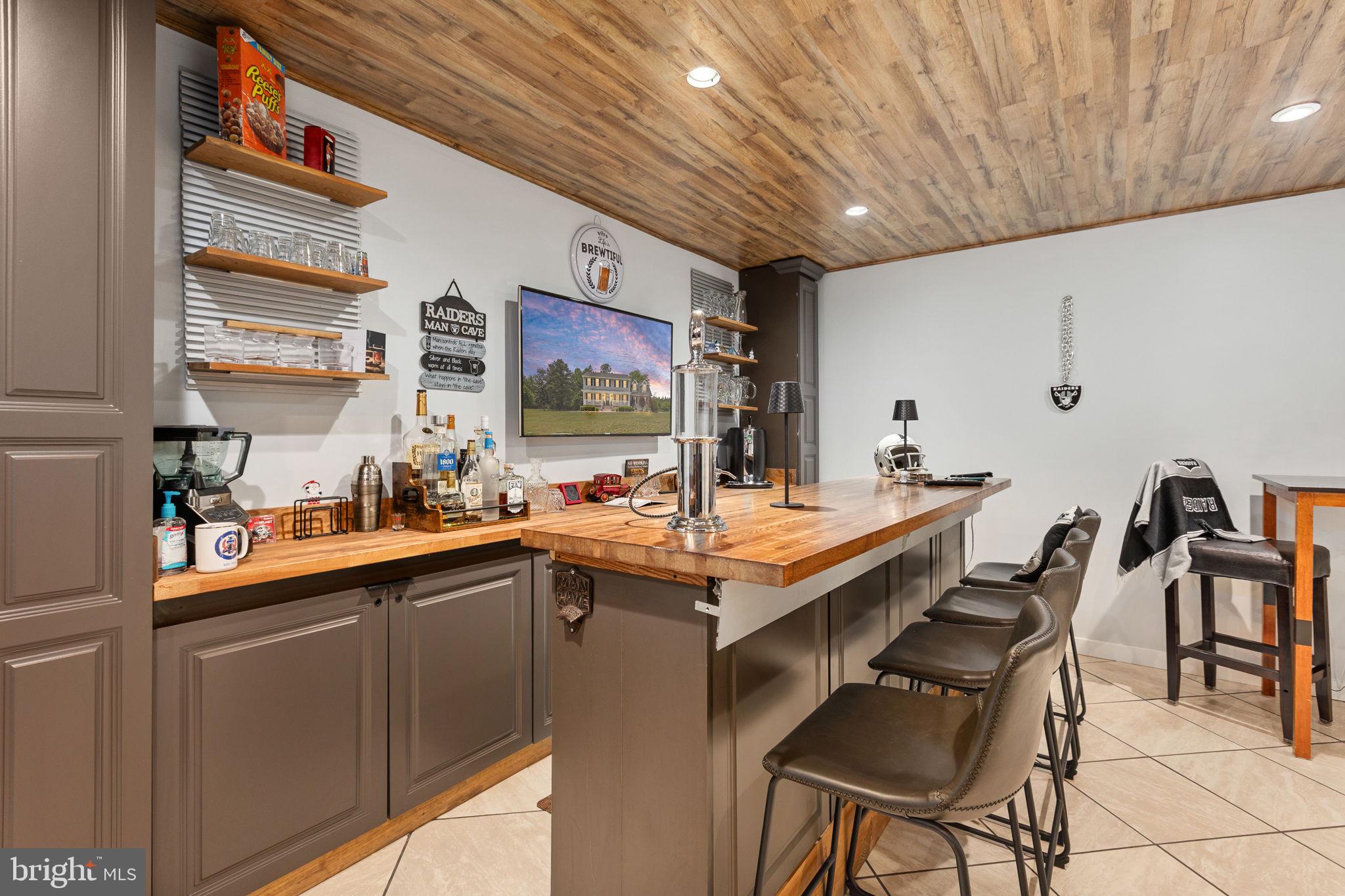 22088 Landora Bridge Road Ruther Glen, VA 22546 - Photo 75 of 122 Stylish home bar with rustic charm.