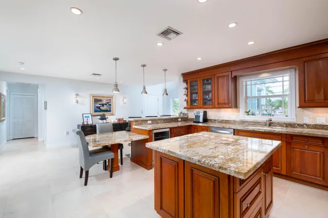 a kitchen with a sink a counter top stainless steel appliances and cabinets