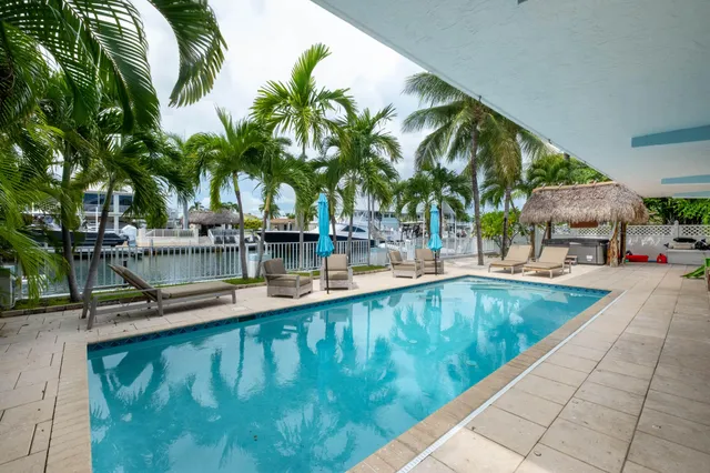 a swimming pool with outdoor seating and yard