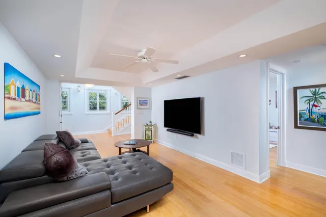 a room with pool table and windows