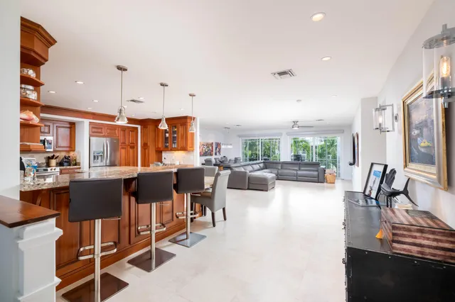 a living room with lots of furniture and a large window