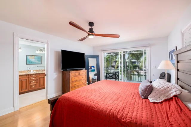 a bedroom with a large bed and a flat screen tv