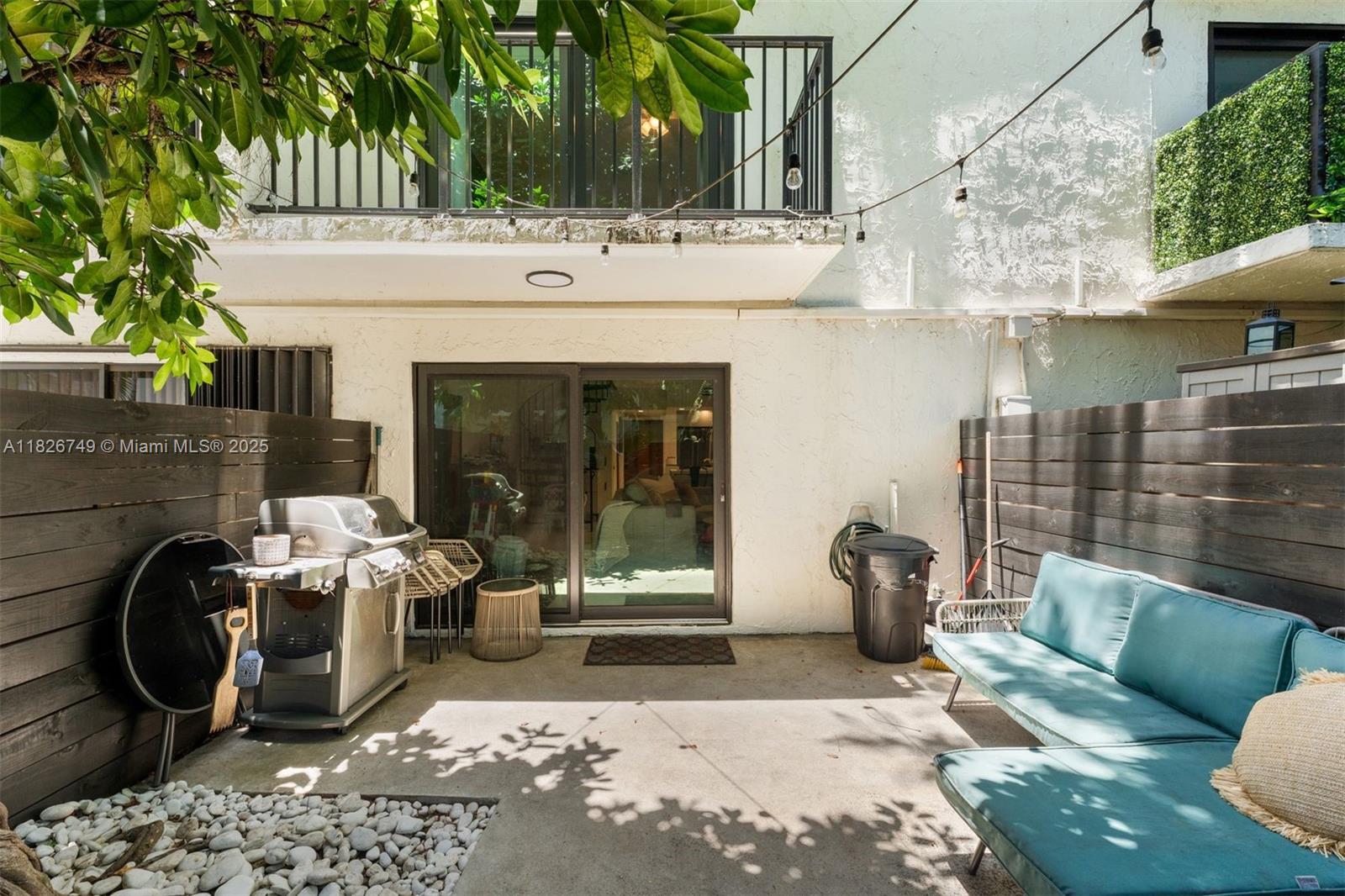 3214 West Trade Avenue, Unit III5 Miami, FL 33133 - Photo 23 of 31 a view of a patio with table and chairs and potted plants
