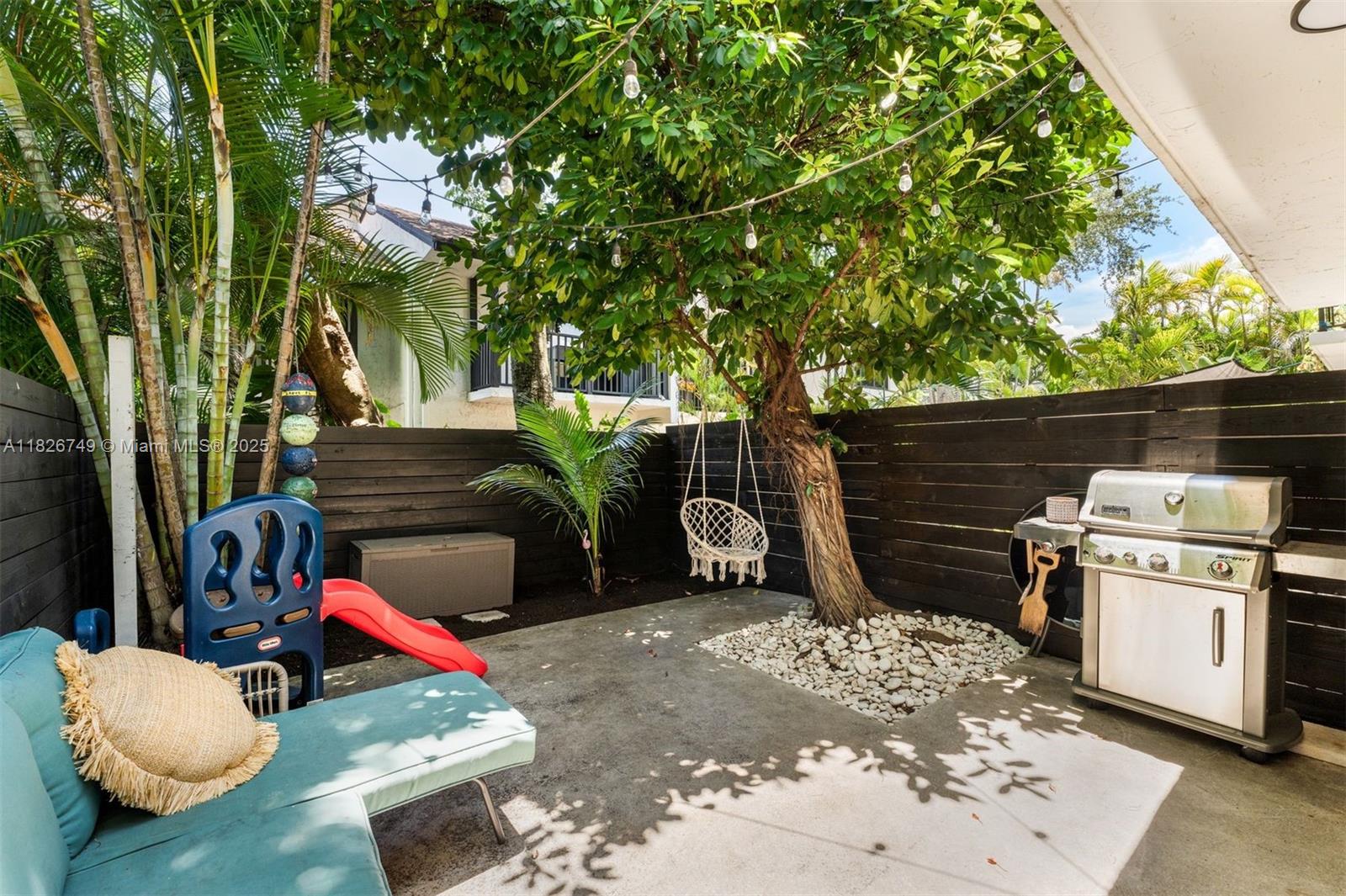 3214 West Trade Avenue, Unit III5 Miami, FL 33133 - Photo 24 of 31 a backyard of a house with barbeque oven and outdoor seating