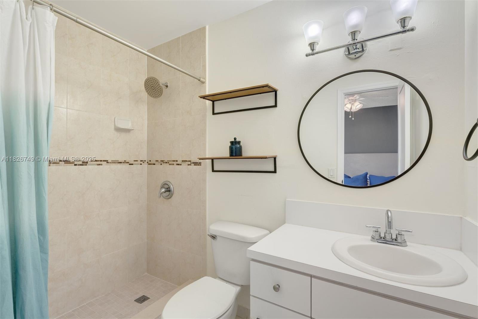 3214 West Trade Avenue, Unit III5 Miami, FL 33133 - Photo 27 of 31 a bathroom with a sink a toilet and a mirror