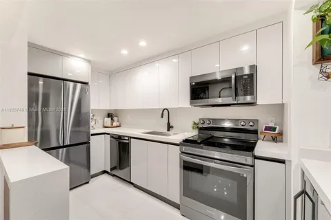 a kitchen with a sink stove and refrigerator