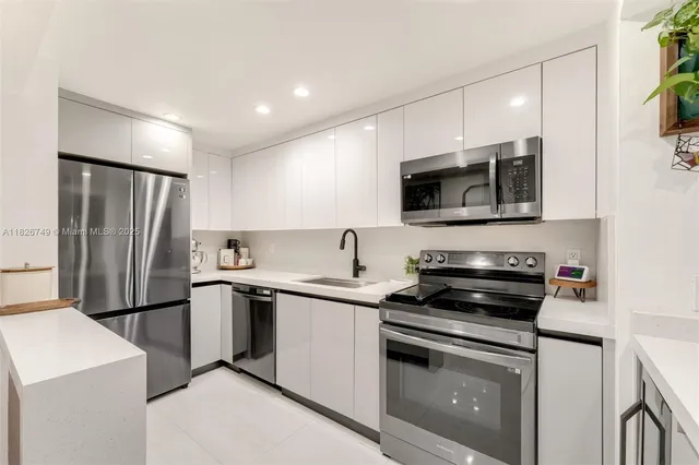 a kitchen with a sink stove and refrigerator