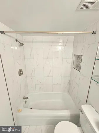 a bathroom with a shower and a bathtub
