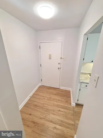 a view of a room with wooden floor and staircase