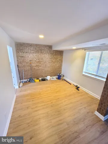 a view of a room with wooden floor