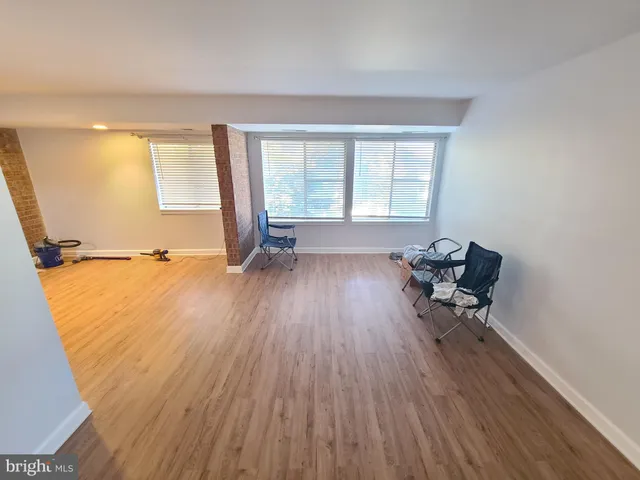 a view of workspace with wooden floor and a window