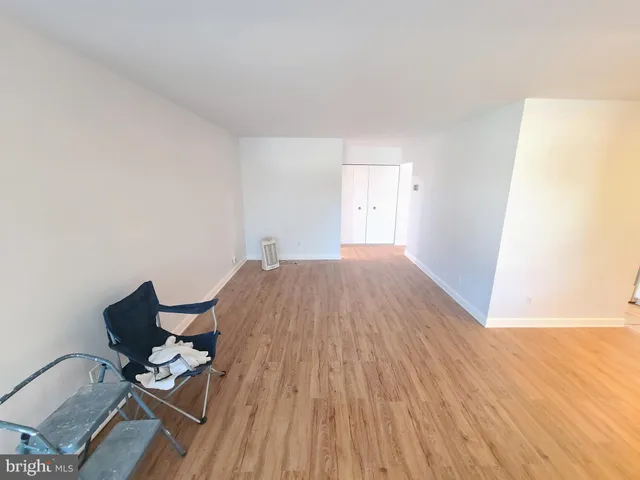 a workspace with wooden floor and a window