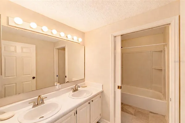 a bathroom with a double vanity sink and a mirror