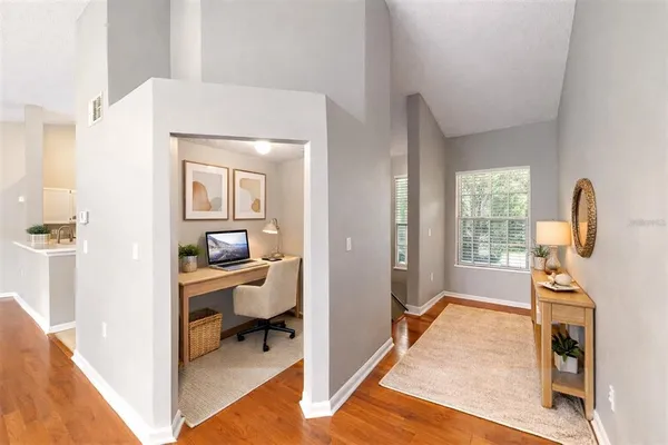 a view of living room filled with furniture and wooden floor