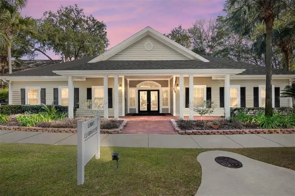 a front view of a house with yard and green space