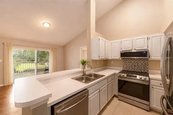 a kitchen that has a sink and a stove