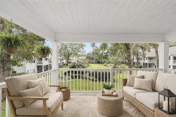 a balcony with furniture and garden view