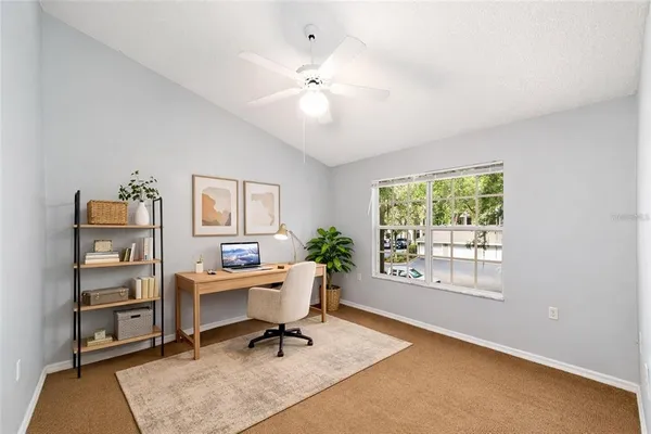 a workspace with wooden floor and a window