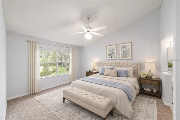 a bedroom with a large bed and a window