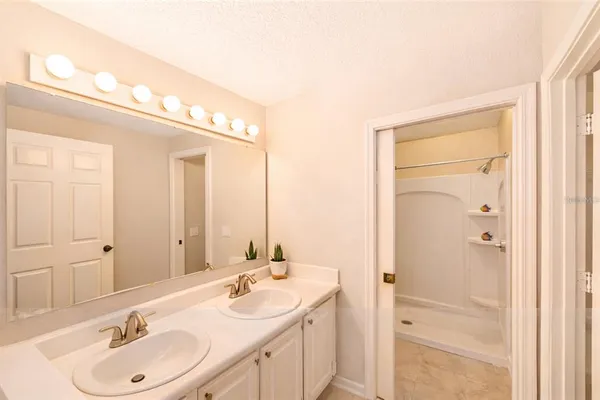 a bathroom with a double vanity sink and a mirror