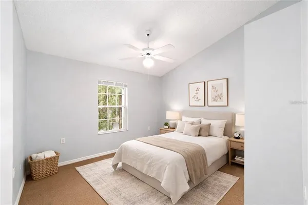 a bedroom with a white bed and a chandelier