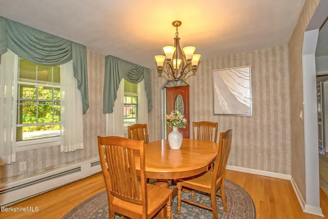 a view of a dining room with furniture wooden floor and chandelier