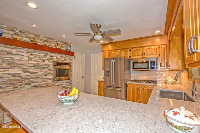 a view of a kitchen with a sink and breakfast area