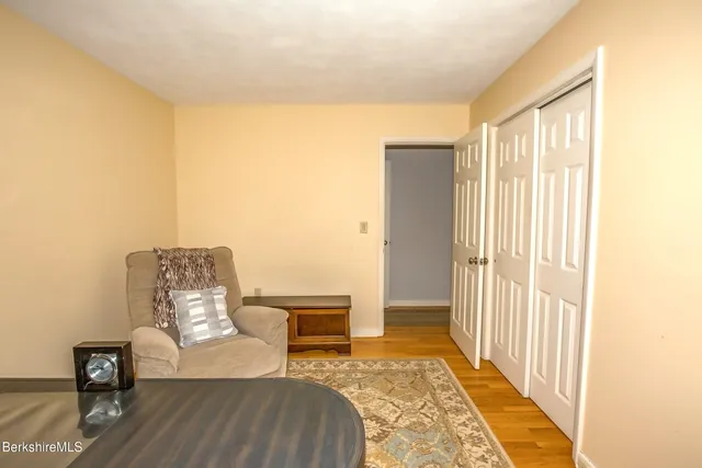 a view of a bedroom with furniture and wooden floor