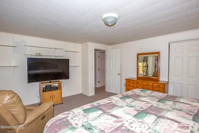 a bedroom with furniture and flat screen tv