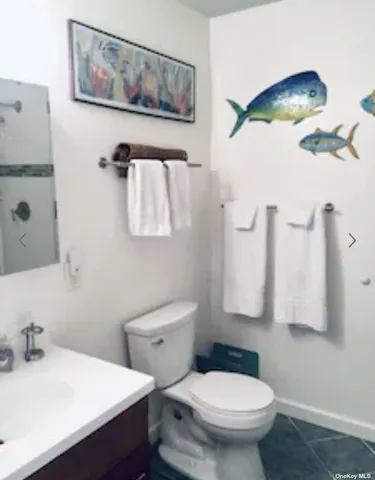 a bathroom with a sink toilet and mirror