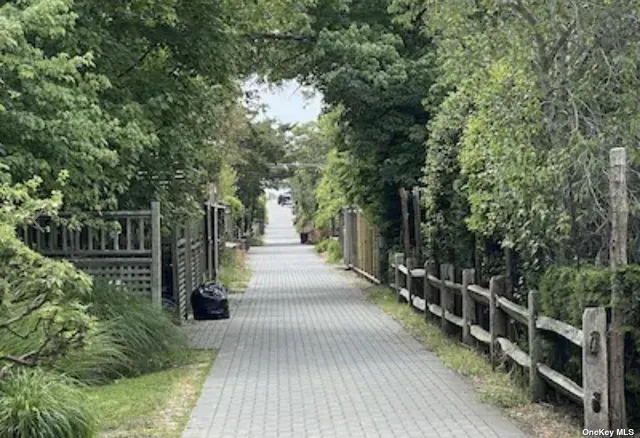 a view of a pathway with a wrought fence