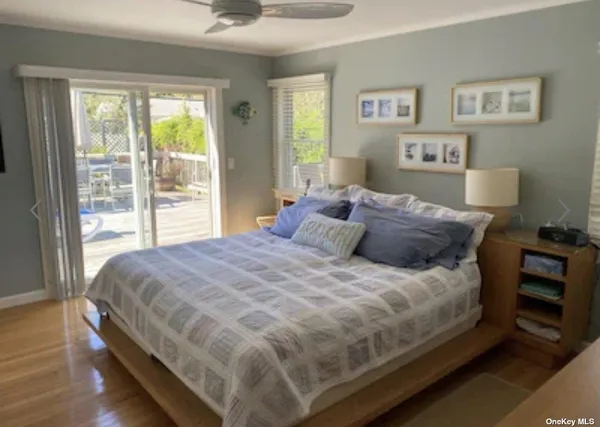 a large bed sitting in a bedroom next to a window