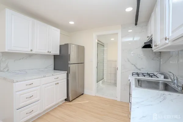 a kitchen with stainless steel appliances granite countertop a refrigerator sink and cabinets