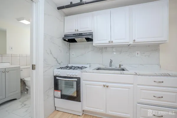 a kitchen with cabinets appliances and a sink