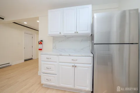 a white refrigerator freezer sitting inside of a kitchen