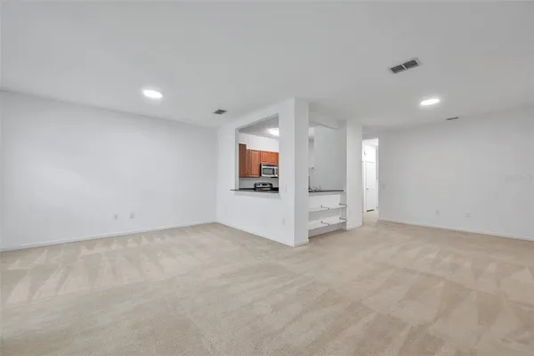 an empty room with a fireplace and windows