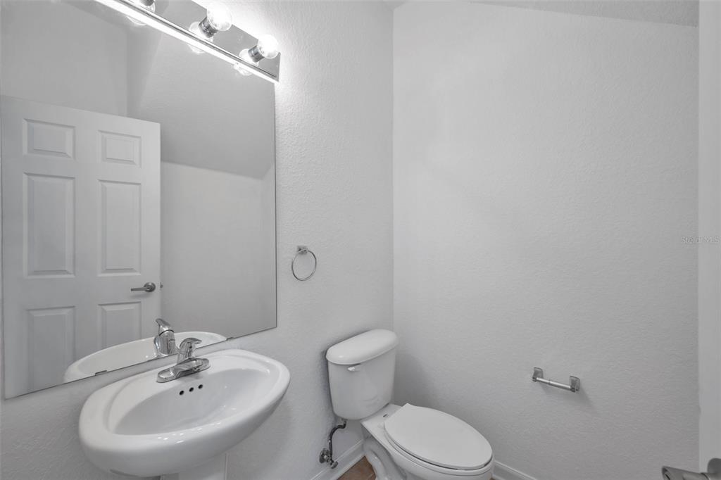8206 Bally Money Road Tampa, FL 33610 - Photo 15 of 43 a bathroom with a sink mirror and toilet