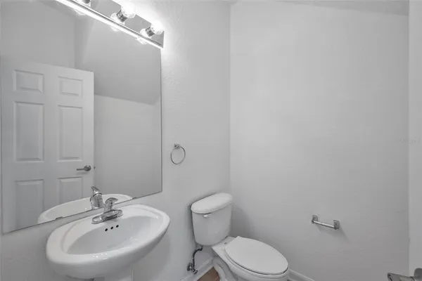 a bathroom with a sink mirror and toilet