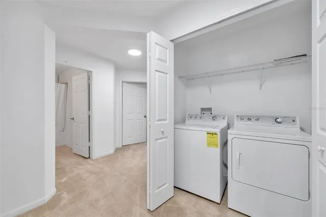 a view of storage and utility room with washer and dryer