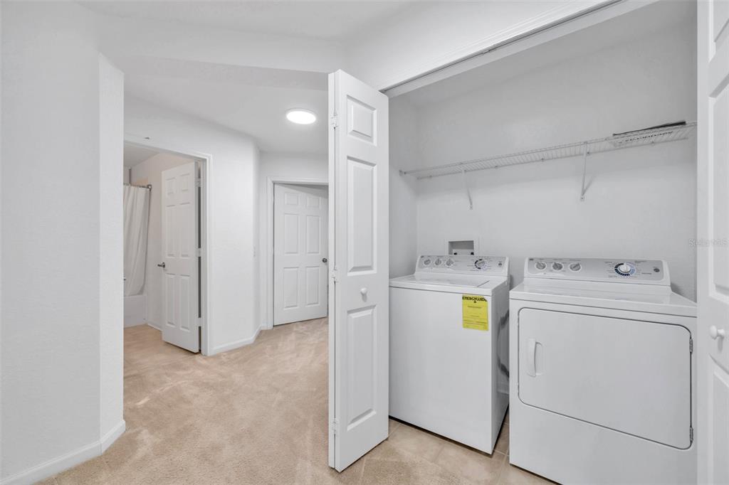 8206 Bally Money Road Tampa, FL 33610 - Photo 17 of 43 a view of storage and utility room with washer and dryer