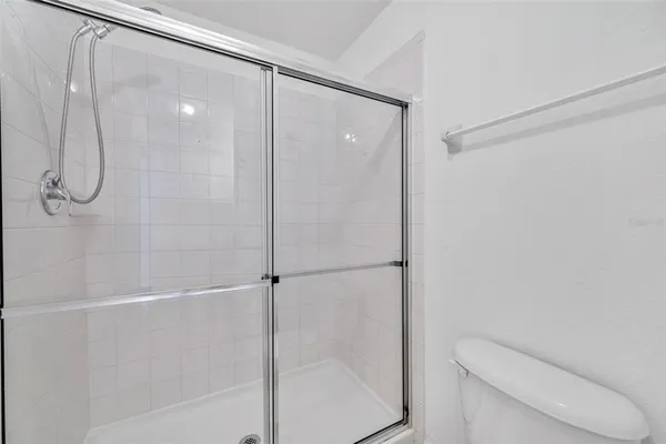 a bathroom with a shower and toilet