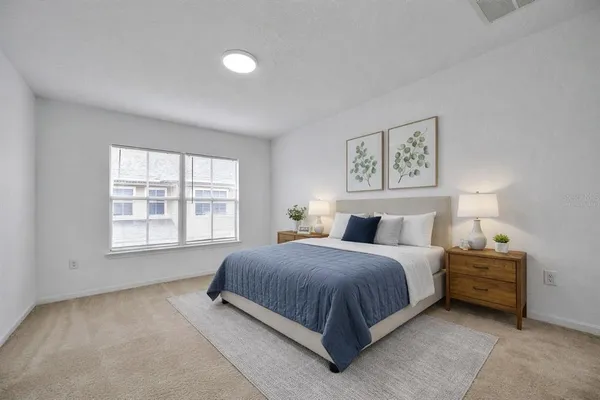 a bedroom with a bed next to a window