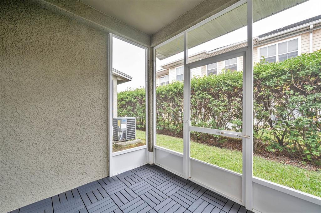 8206 Bally Money Road Tampa, FL 33610 - Photo 35 of 43 a view of an empty room with wooden floor and a window