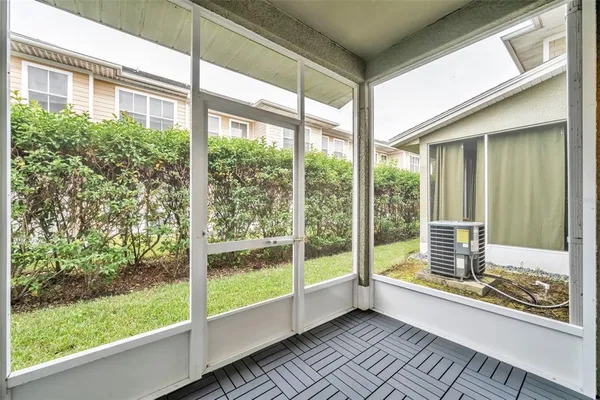 a view of front door and porch with wooden floor