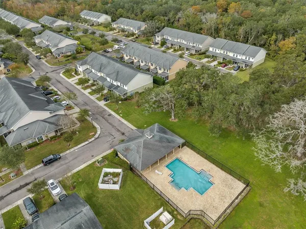 an aerial view of residential houses with outdoor space