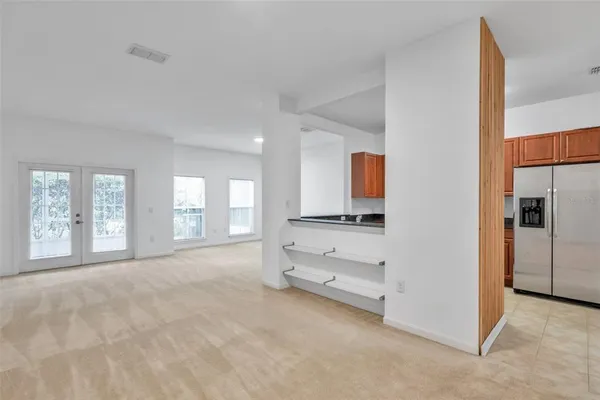 a spacious bedroom with a bed and a large window