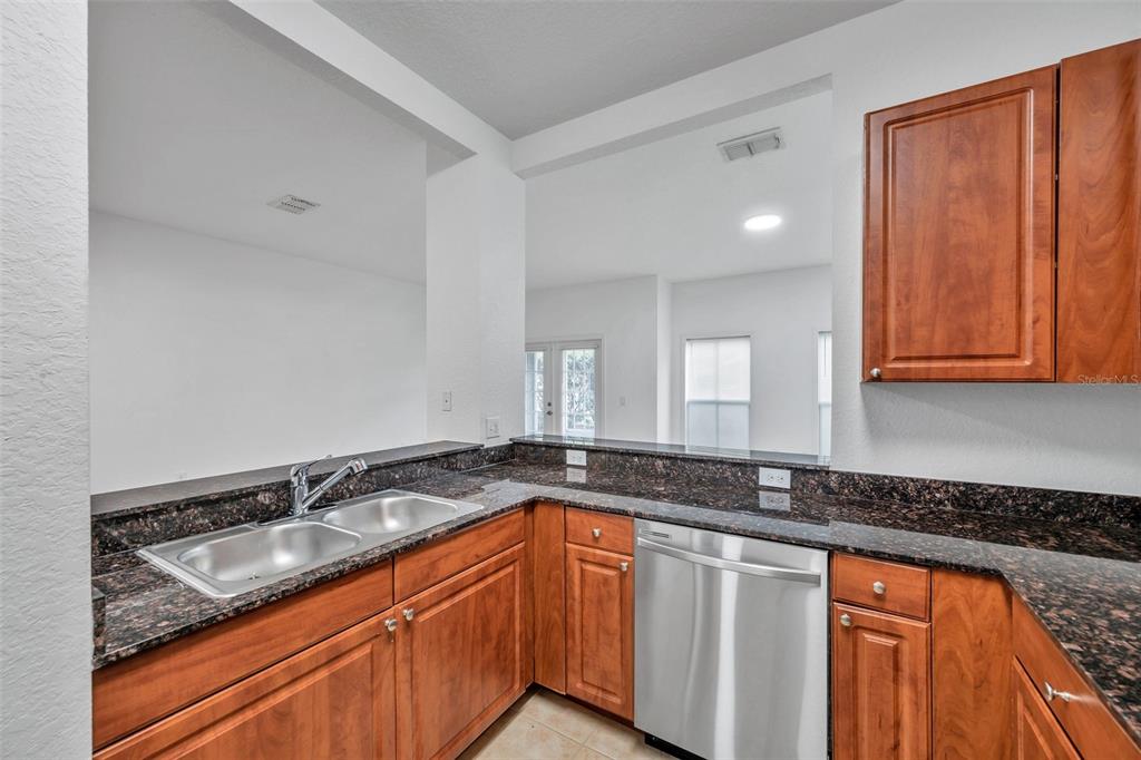 8206 Bally Money Road Tampa, FL 33610 - Photo 8 of 43 a kitchen with granite countertop a sink and cabinets