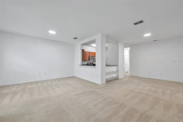 an empty room with a fireplace and windows